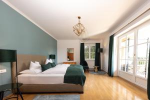 a bedroom with a bed and a large window at Parkvilla 11 in Fürstenfeld