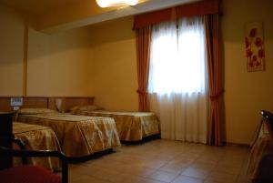 Letto o letti in una camera di Hotel Tre Torri