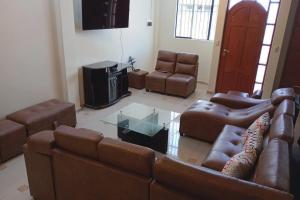 a living room with a couch and a tv at Tambo del Inca in Puno