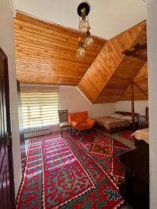 a living room with a large rug on the floor at Жайсан in Karakol