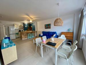a kitchen and living room with a table and chairs at Casa Elena in Candelaria