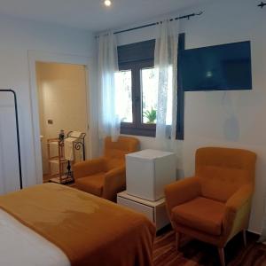 A bed or beds in a room at Restaurante & Hotel Rural El Mirador de Trevejo,ideal para parejas