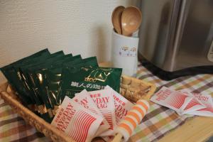 a basket of food on a table next to a microwave at Nozawa Dream in Nozawa Onsen +59 photos