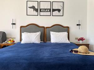 a bedroom with a blue bed with two pillows at Domina Coral Bay Sultan Vista Mare Uno in Banī Ghālib +45 photos