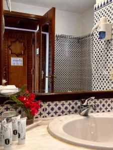 a bathroom with a sink and a mirror at Domina Coral Bay Sultan Vista Mare Uno in Banī Ghālib