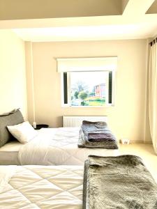 A bed or beds in a room at Grand Afroditi LUX