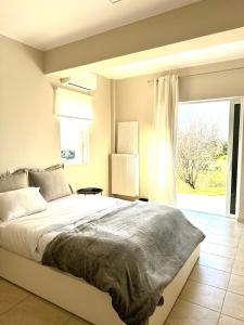 A bed or beds in a room at Grand Afroditi LUX