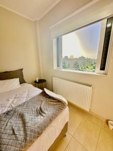 A bed or beds in a room at Grand Afroditi LUX