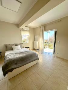 A bed or beds in a room at Grand Afroditi LUX