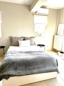 A bed or beds in a room at Grand Afroditi LUX
