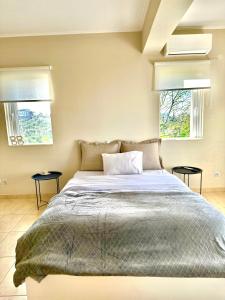 A bed or beds in a room at Grand Afroditi LUX