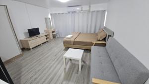 a small room with a bed and a couch at New Room in Nonthaburi