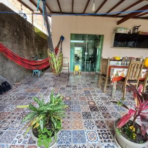 a patio with potted plants on a tiled floor at COP30 Casa Completa in Barcarena