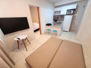 a living room with a flat screen tv and a kitchen at Samambaia East Side · Comfort in Samambaia in Brasilia