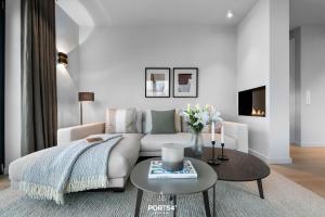 a white living room with a couch and a table at Nordic Suite List auf Sylt in List +21 photos