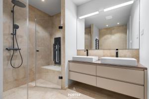 a bathroom with two sinks and a shower at Nordic Suite List auf Sylt in List