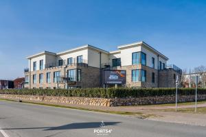 a building on the side of a street at Nordic Suite List auf Sylt in List