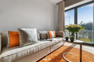 a living room with a couch and a window at Anchorage Suite List auf Sylt in List +24 photos