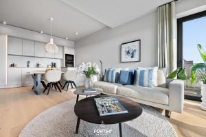 a living room with a couch and a table at Harbourview Suite List auf Sylt in List