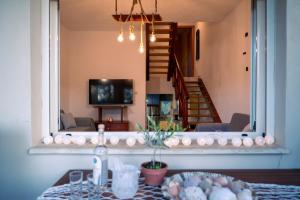 a living room with a table and a mirror at Iro's Paradise in Nikiti