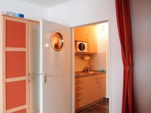 a small kitchen with a sink and a microwave at Ferienwohnung Thordsen 2 in Burgtiefe auf Fehmarn 