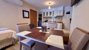 a kitchen with a table and chairs in a room at Entre Cumbres Apart Hotel in Coihaique