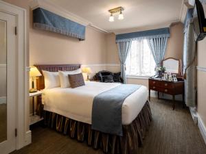 Postel nebo postele na pokoji v ubytování Abigail's Hotel
