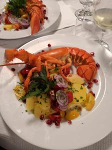 a plate of food with seafood on a table at Casa Vacanza Il Pontile Mini Appartamento in Cipollina