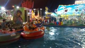 a group of rides at a carnival at night at Casa Vacanza Il Pontile Mini Appartamento in Cipollina