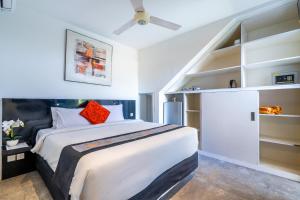 a bedroom with a large bed and a ceiling fan at Bali Yarra Villas - Seminyak in Seminyak +63 photos