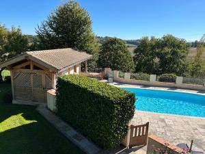 a house with a swimming pool and a gazebo at Chez Jay à Bassoues in Bassoues +8 photos