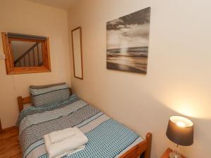 a bedroom with two twin beds and a mirror at Waters Edge in Alnwick