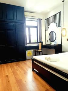 a bedroom with a bed and a desk and a window at MOONTOWN homestay in Hoi An