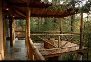 a wooden porch of a cabin in the woods at Cedro B in Pachuca de Soto