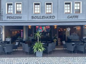 a restaurant with tables and chairs in front of a building at Familien-Apartments Boulevard in Waldsassen