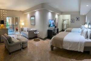 a bedroom with a large bed and a living room at Hollywood Hotel in Los Angeles