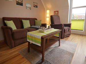 a living room with a couch and a coffee table at Charmante Ferienwohnung in Kirchdorf Insel Poel in Oertzenhof