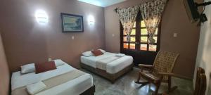 Un pat sau paturi într-o cameră la Hotel Rosa de los vientos