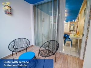 a balcony with two chairs and a table at Casa María in Isla Mujeres