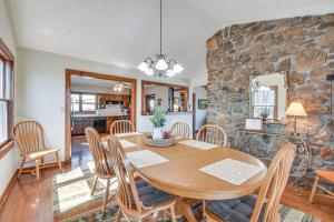 a dining room with a table and chairs and a stone wall at Mountain-View Home with Deck and Grill in Dahlonega in Dahlonega