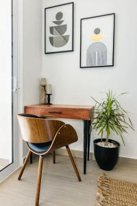a desk and a chair in a room with a plant at Ultimate Beach Escape 2-Bedroom in Puerto Penasco in Playa Encanto