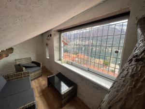 una stanza con una grande finestra con vista di Timco 3-story apartment with lake view and air-conditioner a Torno