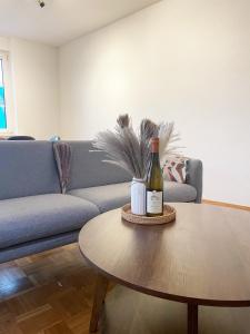 a bottle of wine sitting on a table in a living room at Charmante Ferienwohnung im Herzen der Koblenzer Altstadt in Koblenz