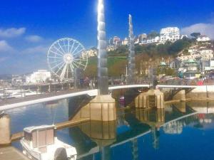 a view of a ferris wheel and a bridge and water at 74Belgravia in Torquay