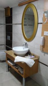 a bathroom with a sink and a mirror at Start Hotel in Antalya