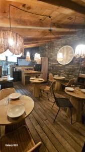 a restaurant with tables and chairs in a room at Domaine COLONNA SANTINI ,Chambre d hôtes Piscine, sauna, spa in Porri