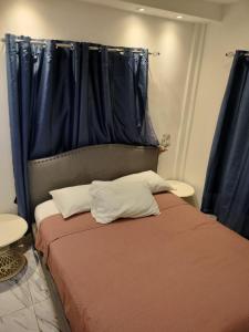 a bedroom with a bed with a blue curtain at Vacacional Laas Pascualas in Sánchez +13 photos