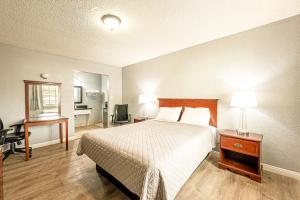 Ένα ή περισσότερα κρεβάτια σε δωμάτιο στο Villa Motel