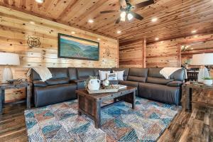 a living room with a leather couch and a table at Smoky Mountain Splash in Sevierville