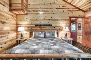 a bedroom with a bed in a log cabin at Smoky Mountain Splash in Sevierville +64 photos